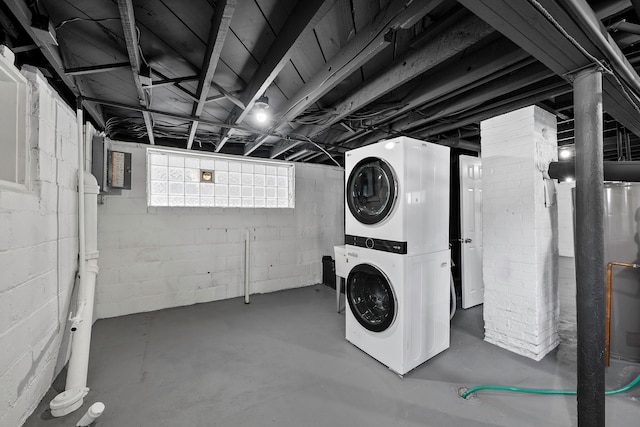 laundry area with stacked washer / dryer and laundry area