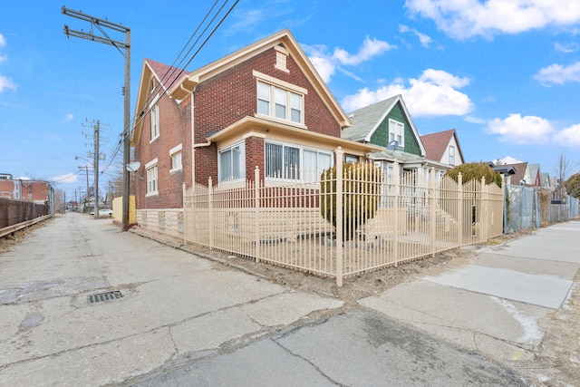 view of front facade with a fenced front yard and brick siding