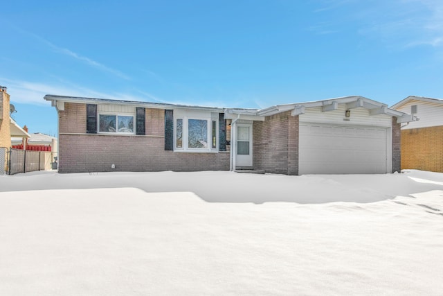 ranch-style house with brick siding and an attached garage