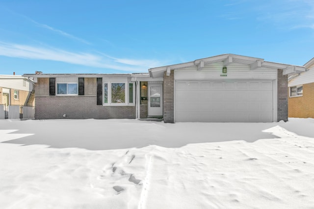 view of front of house with a garage and brick siding