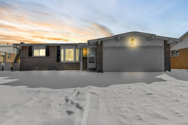 view of front of property with an attached garage and brick siding