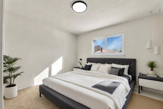 bedroom featuring baseboards and light colored carpet