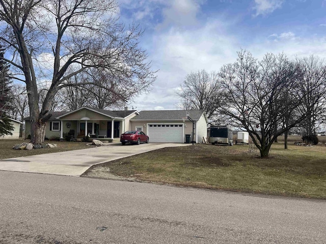 ranch-style home featuring a garage, a front yard, and concrete driveway