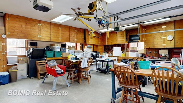 garage with a workshop area and a garage door opener