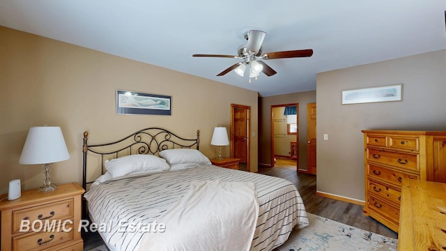 bedroom featuring ceiling fan, baseboards, and dark wood-type flooring