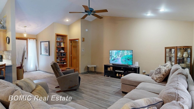 living area featuring light wood finished floors, baseboards, high vaulted ceiling, and recessed lighting