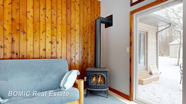 living area with carpet and a wood stove