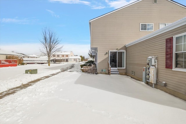 view of snow covered exterior with entry steps