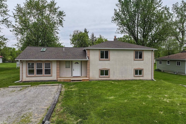 7447 E Bristol Rd, Davison, MI 48423 - split level home featuring a chimney, a front yard, roof with shingles, and stucco siding