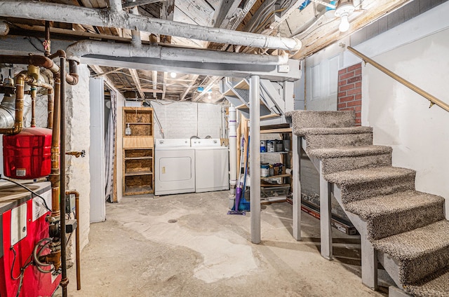 unfinished below grade area featuring stairway and independent washer and dryer