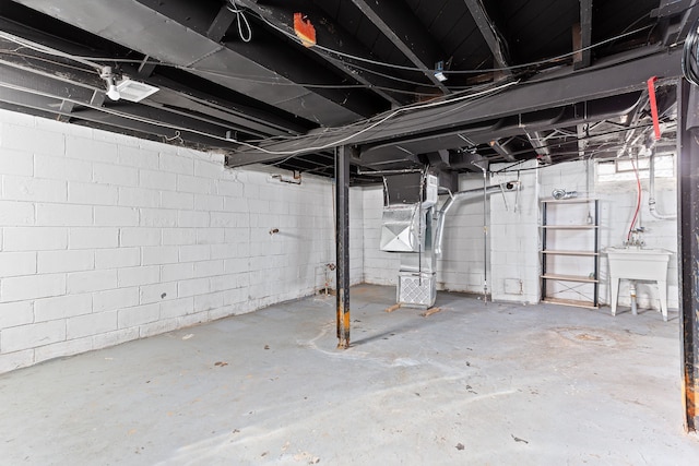 unfinished basement with heating unit and a sink