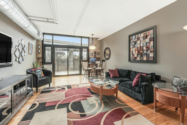 living room with light hardwood / wood-style flooring and expansive windows