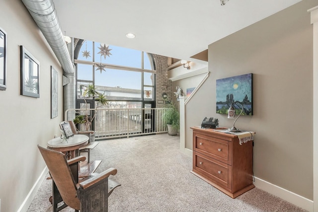 sitting room featuring light colored carpet