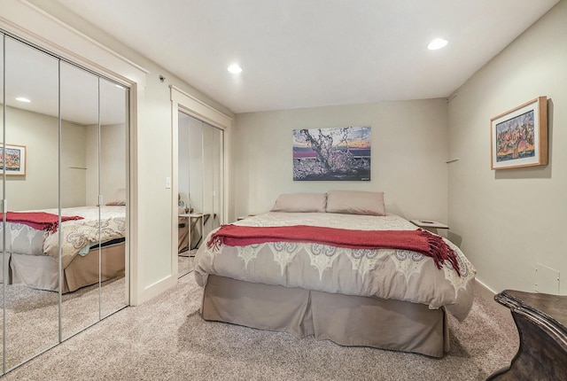 carpeted bedroom featuring multiple closets