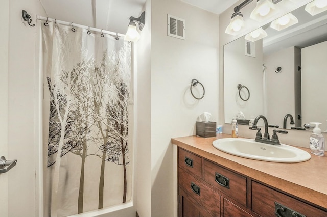 bathroom featuring vanity and curtained shower