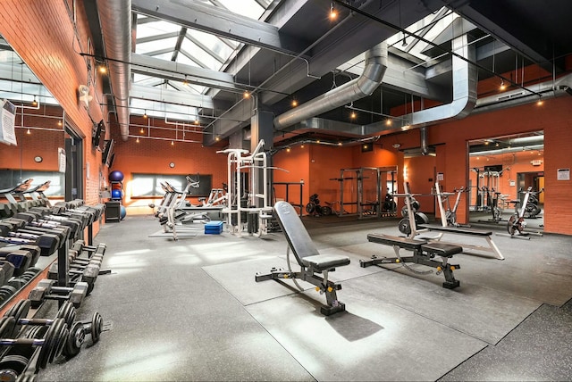 workout area featuring a towering ceiling