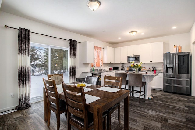 dining room with dark wood-type flooring