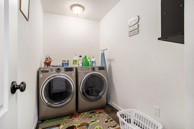 washroom featuring hardwood / wood-style flooring and washing machine and clothes dryer