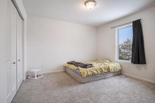 unfurnished bedroom with a closet and carpet flooring