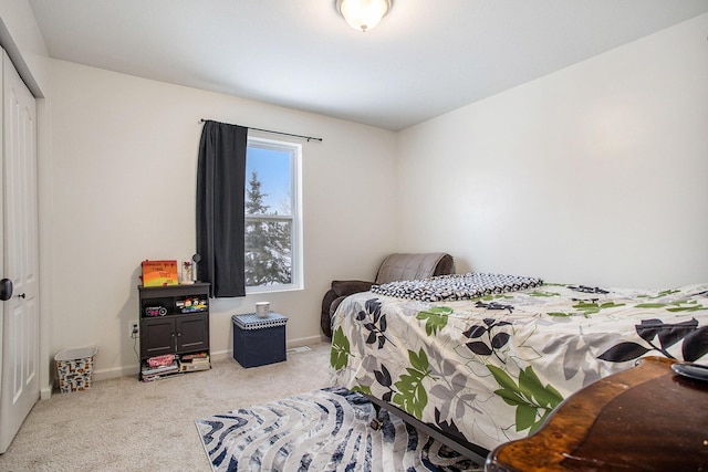 bedroom featuring light carpet and a closet