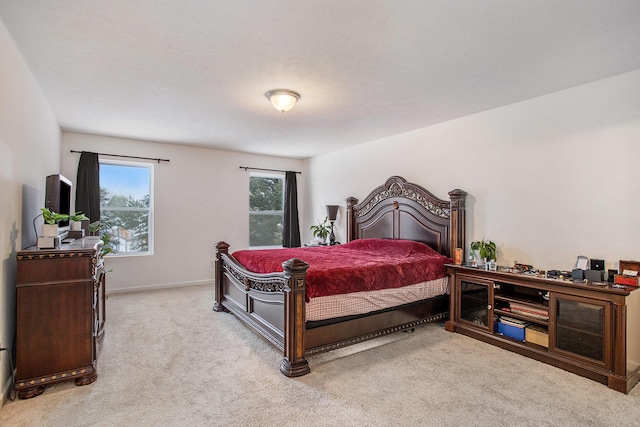 bedroom featuring light carpet