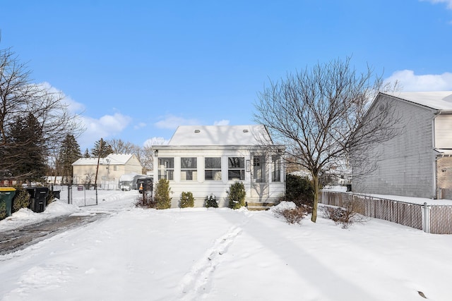 view of snow covered back of property