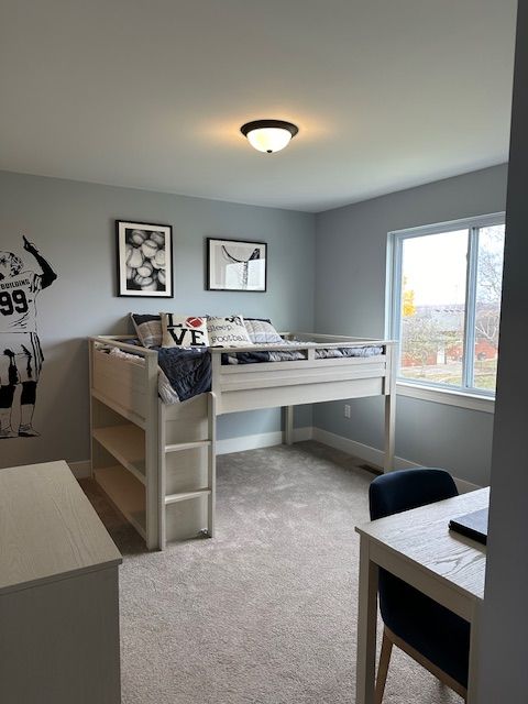 bedroom with carpet floors and baseboards