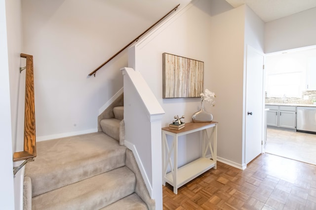 staircase featuring baseboards