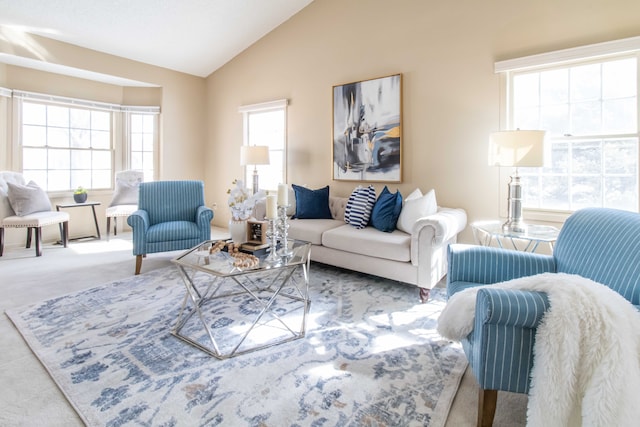 living area featuring vaulted ceiling and light colored carpet