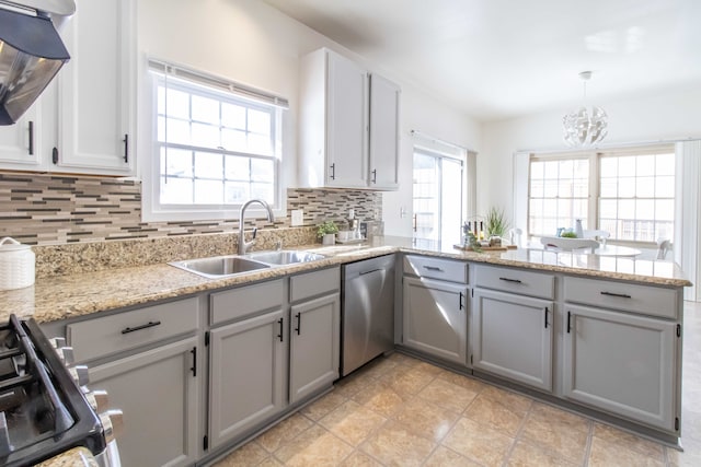 kitchen with range with gas stovetop, gray cabinets, a sink, and stainless steel dishwasher