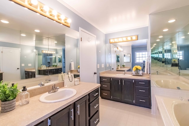 bathroom with a garden tub, two vanities, a sink, and crown molding