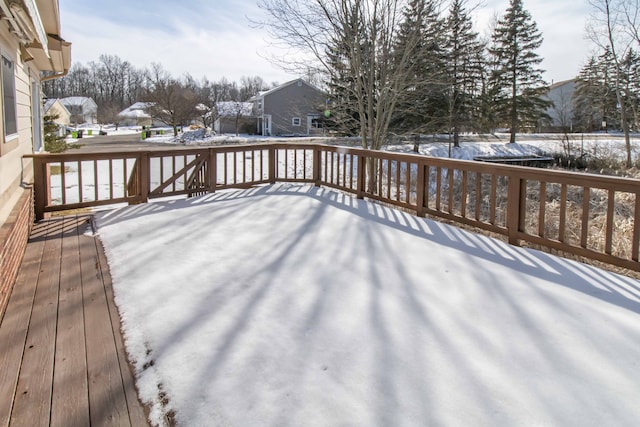 snow covered deck with a residential view