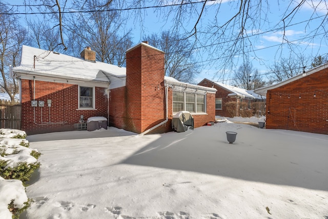 view of snow covered rear of property