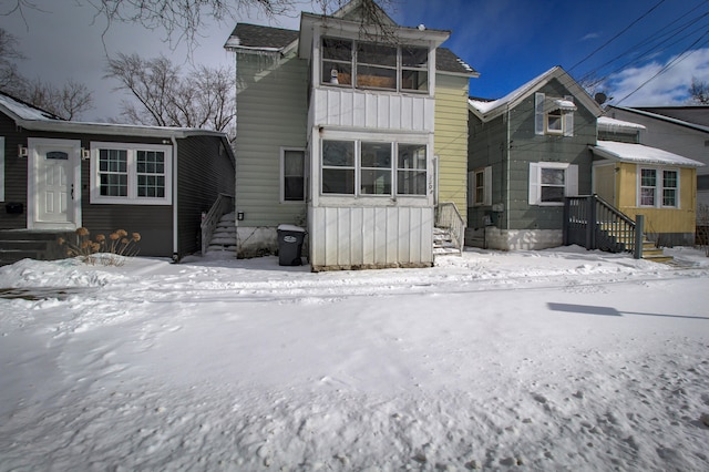 view of snow covered rear of property