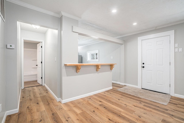 entrance foyer with light wood-style floors, baseboards, crown molding, and recessed lighting