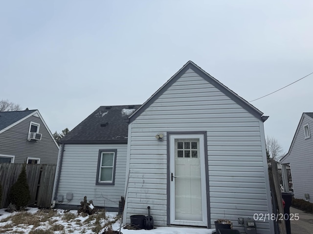 view of snow covered rear of property