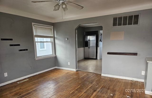 empty room with ceiling fan and dark wood-type flooring