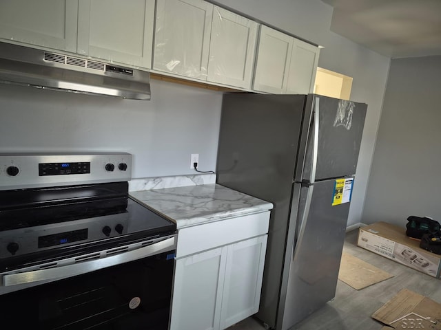 kitchen featuring under cabinet range hood, light stone counters, appliances with stainless steel finishes, wood finished floors, and white cabinets