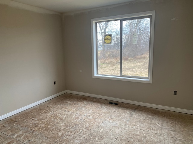 unfurnished room with visible vents and baseboards