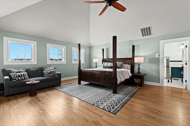 bedroom with high vaulted ceiling, hardwood / wood-style floors, and ceiling fan