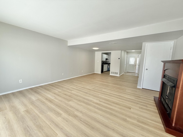 unfurnished living room featuring light hardwood / wood-style flooring