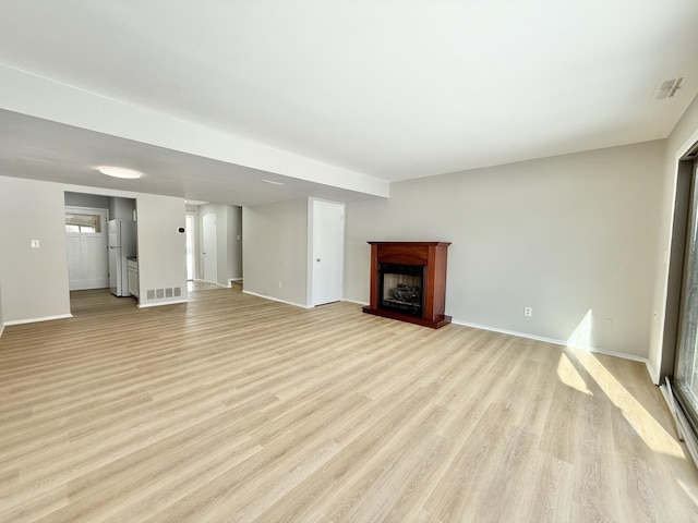 unfurnished living room featuring light hardwood / wood-style floors