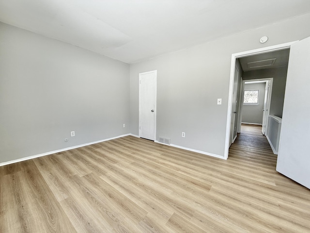 spare room with light wood-type flooring