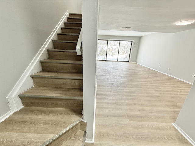 stairway with hardwood / wood-style flooring