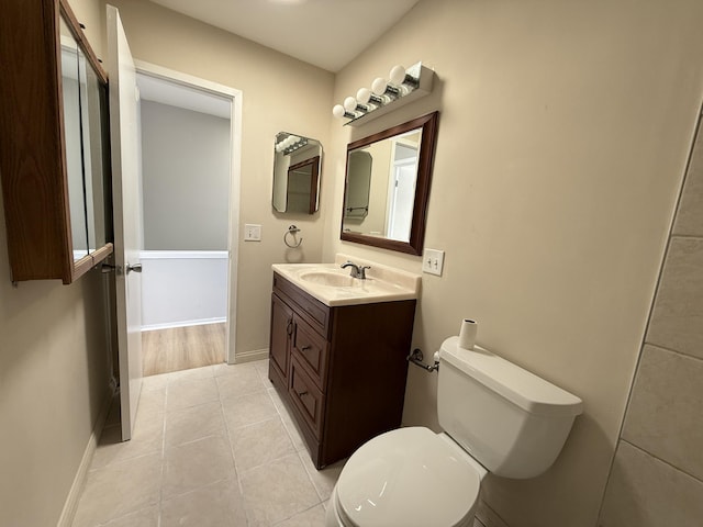 bathroom with vanity, toilet, and tile patterned floors