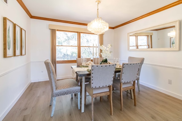 dining space featuring baseboards, wood finished floors, an inviting chandelier, and ornamental molding