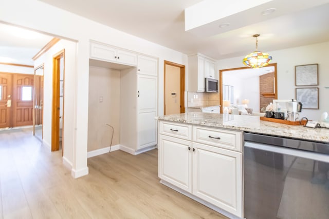 kitchen with light stone counters, light wood-style floors, appliances with stainless steel finishes, white cabinets, and baseboards