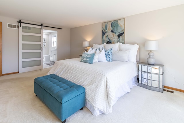 bedroom with a barn door, baseboards, visible vents, and carpet flooring