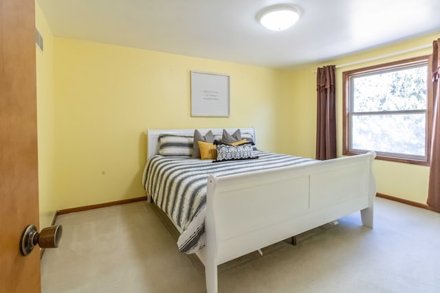 carpeted bedroom with baseboards