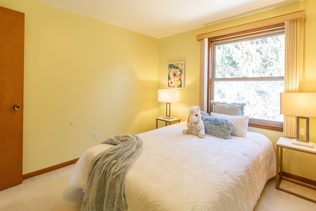 bedroom featuring baseboards and light colored carpet